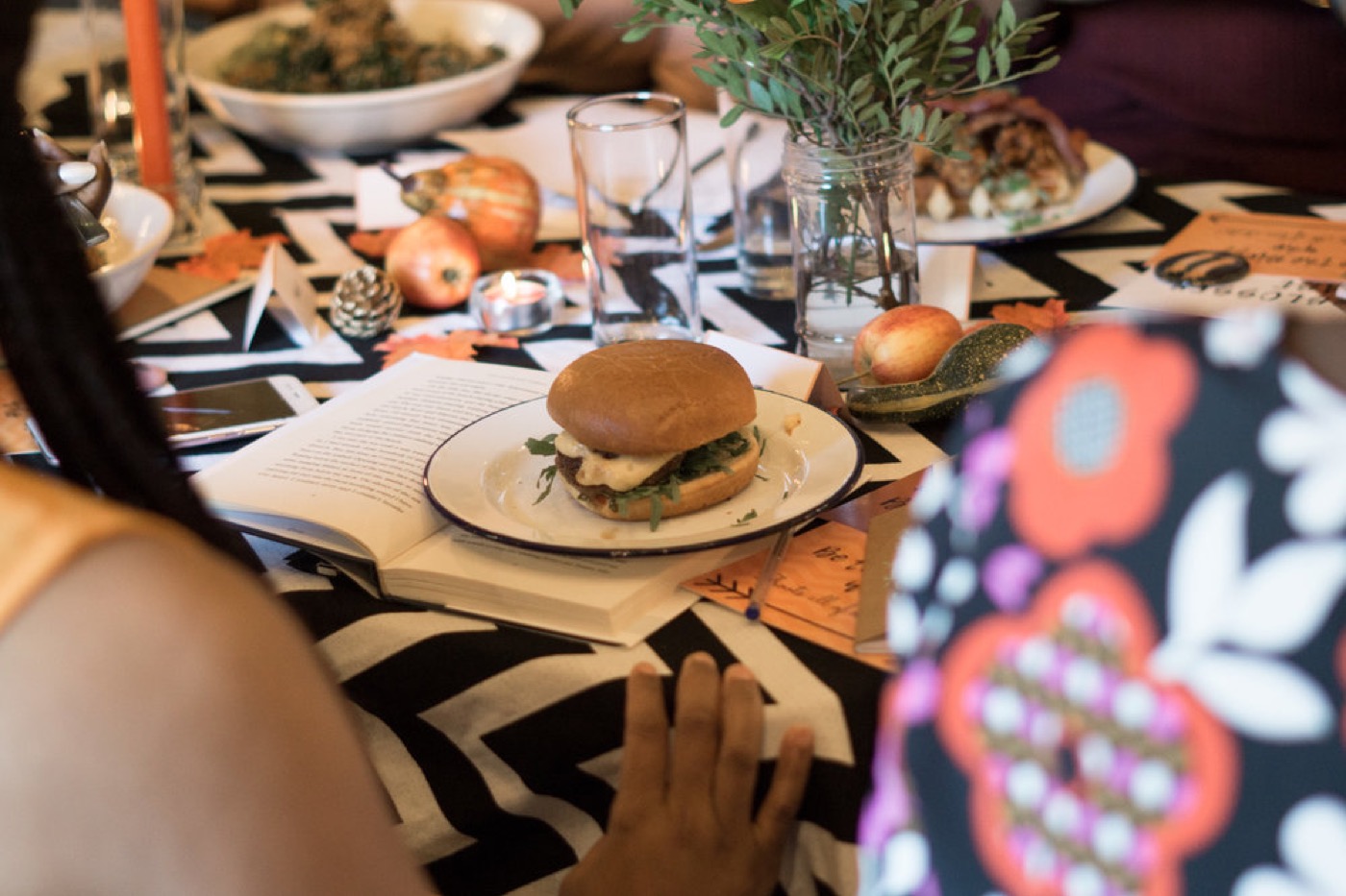 A book and plate styled on a decorated table