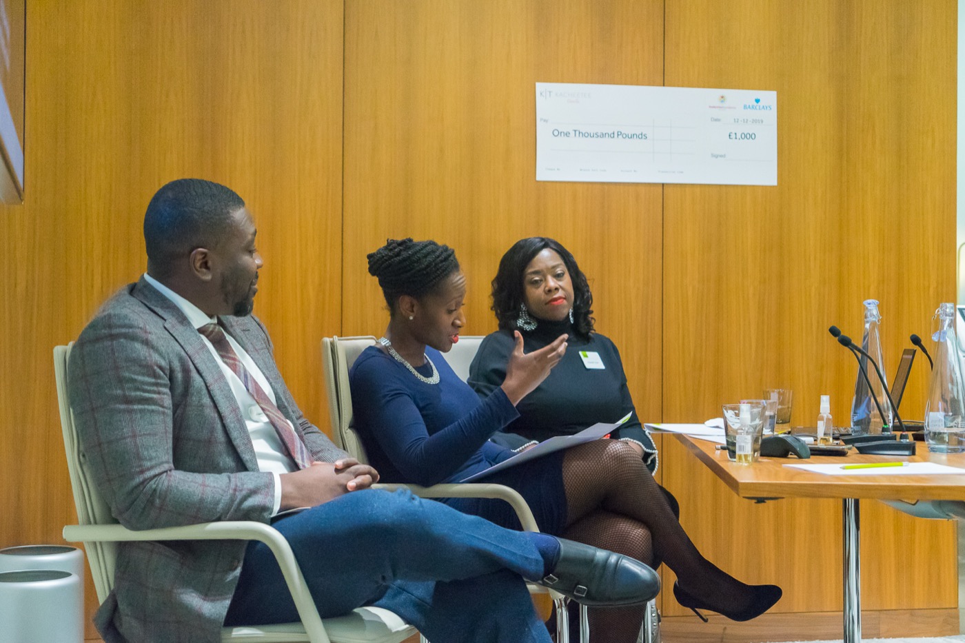Three people in conversation during a panel discussion