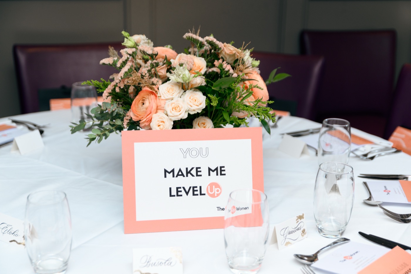 A floral centrepiece with a sign reading You Make Me Level Up